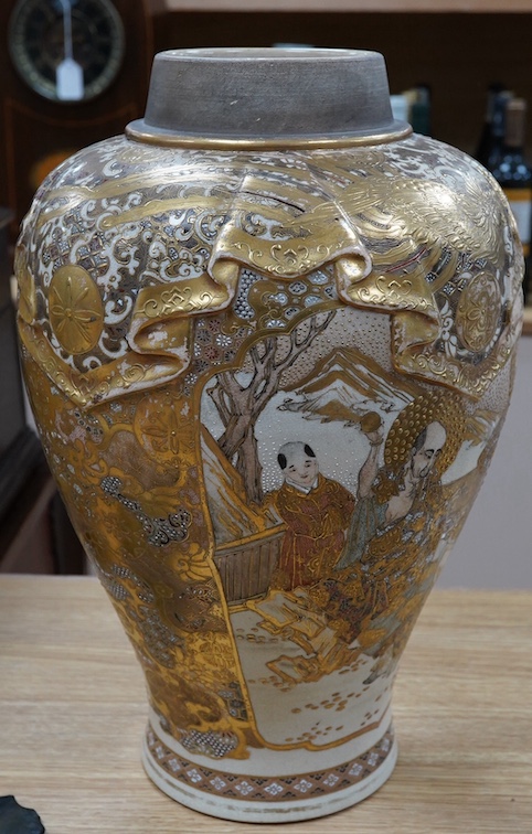 A large Japanese satsuma pottery vase, decorated in relief, Meiji period, 40cm high. Condition - fair